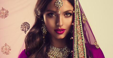 portrait of beautiful indian girl . young hindu woman model in sari and kundan jewelry . traditional