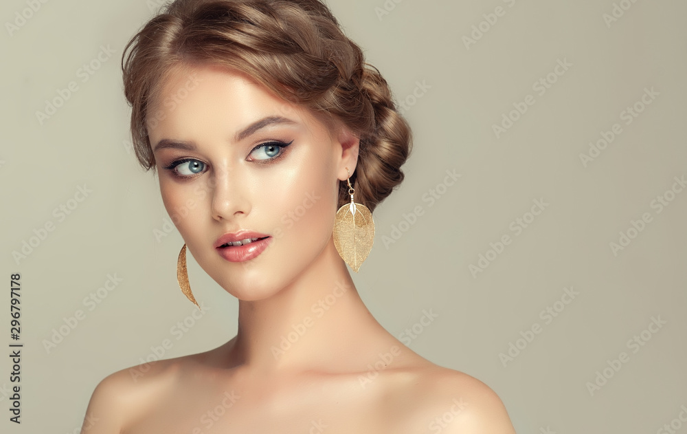 Beautiful model girl with elegant hairstyle and fashionable leaflet earrings . Woman with fashion  hair   and  accessories and jewelry .. - obrazy, fototapety, plakaty 