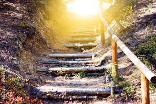 Walk into light  .  Stairs in autumn park .  Way to heaven . Stairs in sky . Religion for the person . Religious background . Way to success