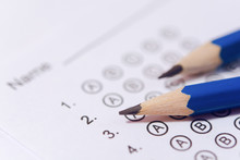 Pencil On Answer Sheets Or Standardized Test Form With Answers Bubbled. Multiple Choice Answer Sheet	