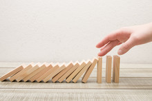 Hand Stops Falling Wooden Dominoes, White Ofn, Domino Principle, Business Concept