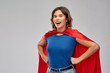 © Syda Productions - women's power and people concept - happy woman in red superhero cape over grey background