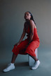 © Adam Perez - Studio shot of stylish young woman in red dress
