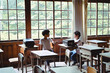 © Taishi Arashida - Students looking each other in classroom
