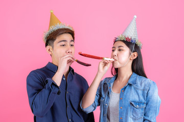 Portrait cheerful young couple with party prop