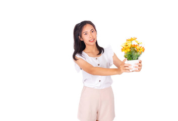 Wall Mural - An Asian girl in white tank top and baige trunk holds yellow plastic flowers in her hands.