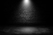 Abstract image of Spot lighting with black brick wall in background.