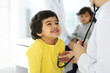 © Iryna - Doctor examining a child patient by stethoscope. Cute arab boy at physician appointment. Medicine and healthcare concept