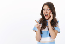 Impressed Excited Young Woman Check Out Awesome Promo, See Cool Product, Pointing Left Stare Copy Space Astonished And Amused, Standing Delighted And Surprised White Background