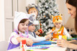 © Oksana Kuzmina - Kids with teacher make hands crafts in kindergarten. Children prepare to christmas in daycare. Group orf preschoolers on lesson in classroom