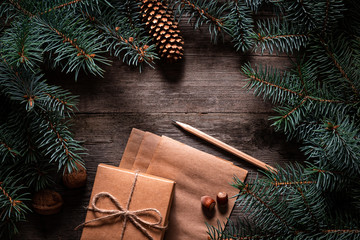Wall Mural - A frame of fir branches and  gift paper box tied with twine. Christmas card blank.