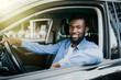 © F8  \ Suport Ukraine - Happy young african american man driving a car on street roads
