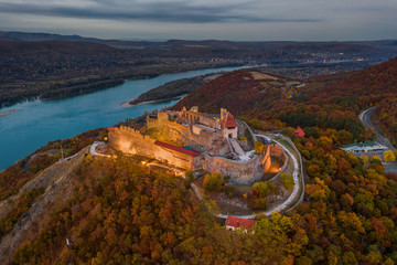 Wall Mural - Visegrad, Hungary - Aerial drone view of the beautiful high castle of Visegrad with autumn foliage and trees. Dunakanyar at background