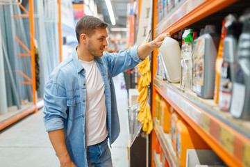 Wall Mural - Man choosing repair materials in hardware store