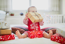 Happy Little Baby Girl Opening Christmas Presents On Her Very First Christmas