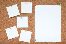 A Sheets Of Paper Are Attached To The Cork Board With A Push-buttons. Empty Note Papers Pinned On Corkboard