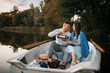 © Nomad_Soul - Love couple with thermos in a boat on quiet lake