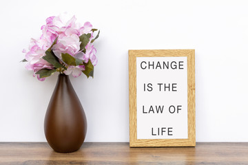 Wall Mural - Change is the law of life - Inspiration quotes on wooden frame.