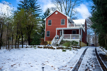 Wall Mural - red suburban house after the first snow of the season in November in the East Coast USA