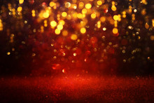 Background Of Abstract Red And Gold Glitter Lights. Defocused