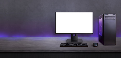 Fototapete - Gaming computer on desk with isolated screen for mockup. Free space beside for promo text. Modern computer with RGB light.