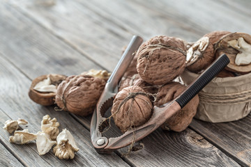 Sticker - Organic Walnut lies on a wooden background , close-up .