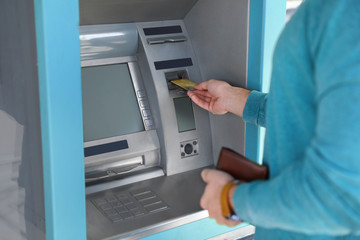 Sticker - Young man using modern cash machine outdoors, closeup