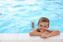 Cute Little Boy In Outdoor Swimming Pool