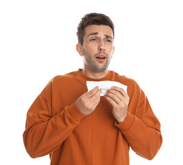 Wall Mural - Young man suffering from cold on white background