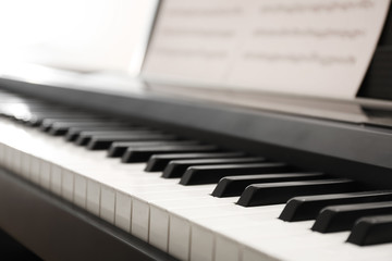 Sticker - Modern piano with music sheets in room, closeup