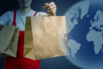 Diverse of paper containers for takeaway food. Delivery man is carrying