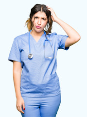 Sticker - Young adult doctor woman wearing medical uniform confuse and wonder about question. Uncertain with doubt, thinking with hand on head. Pensive concept.