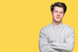 © Krakenimages.com - Young handsome sporty man wearing sweatshirt over isolated background happy face smiling with crossed arms looking at the camera. Positive person.