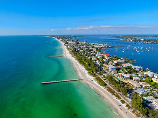 Aerial view of Cortez beach withe sand beach and his little wood pier on blue water, Anna Maria Island, Florida, USA