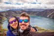 Couple of turists taking a selfie in the Quilotoa lagoon. Ecuador, South America