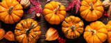 Fototapeta  - Autumn decorative pumpkins with fall leaves on wooden background. Thanksgiving or halloween holiday, harvest concept. Top view, copy space. Greeting card