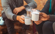 © Prostock-studio - Hands of hikers cheering up with camping cups