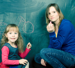 teacher with little girl at blackboard, lifestyle people concept