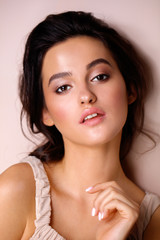 Wall Mural - portrait of a model with professional makeup on a beige background