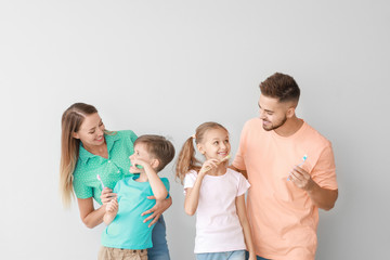 Wall Mural - Portrait of family brushing teeth on light background