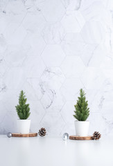 Wall Mural - christmas tree with pine cone,decor xmas ball on wood log at white table and marble tile wall background.clean minimal simple style.holiday still life with space to adding text