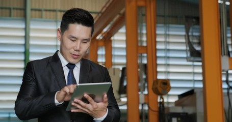 Business man using tablet for work at factory. Industry and Business concept.