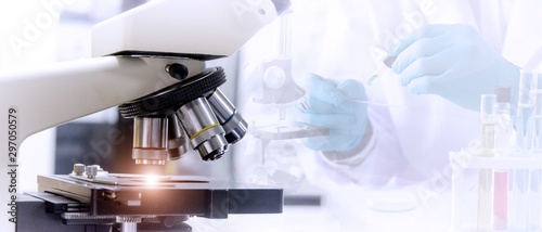 Cuadros en Lienzo Laboratory concept: Close up picture of microscope with blurred background of scientist preparing the sample for testing in laboratory
