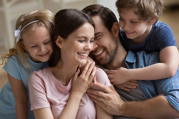 Wall Mural - Happy family enjoying tender moment, parents and children hugging