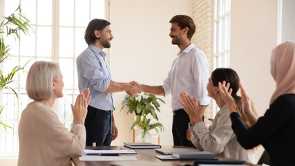 Wall Mural - happy proud manager handshake promote male worker, employee recognition concept