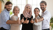 © fizkes - Happy multicultural business team show thumbs up looking at camera