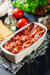 Wall Mural - Hot tasty lasagna with spinach in ceramic casserole dish