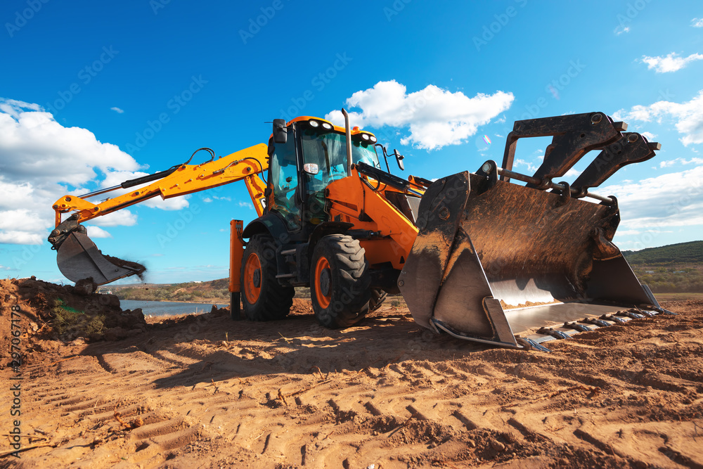 Wheel loader excavator with field background during earthmoving work, construction building - obrazy, fototapety, plakaty 
