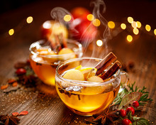 Mulled Cider With Apple Slices, Cinnamon, Cloves, Anise Stars And Citrus Fruits In Glass Cups On A Wooden Rustic Table. Delicious Christmas Hot Drinks On A Wooden Rustic Table. 