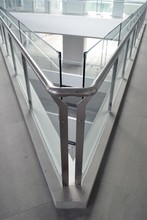 Vertical Shot Of Glass Surfaces Forming A Sharp Angle In A Modern Building